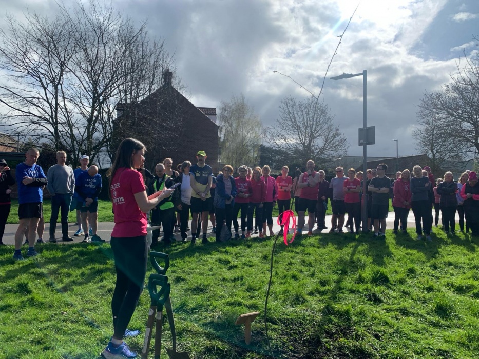 A large group of men and women watching as a rowan tree is dedicated to volunteers at Beverley Fitmums & Friends