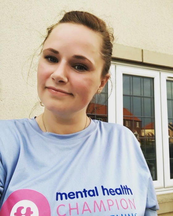 image of lady wearing a mental health champion t-shirt