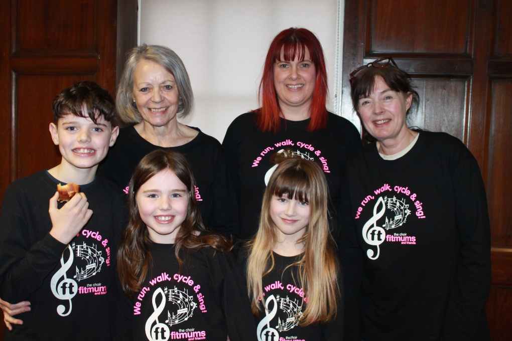 Six family members of different ages in choir t-shirts