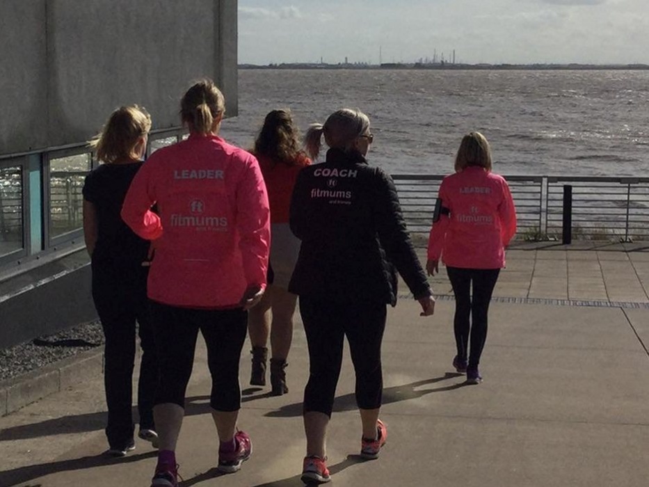 A group walking next to water