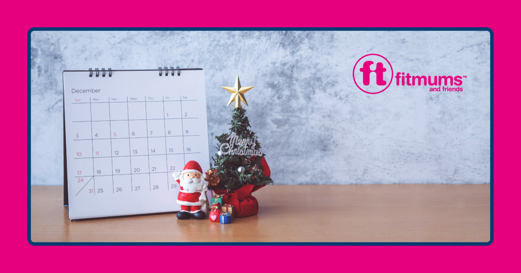 A December calendar displayed next to a miniature Christmas tree, presents and Santa.