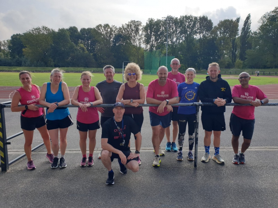 A group of runners at an athletics track