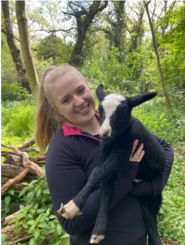 Emily holding Tipsy the lamb
