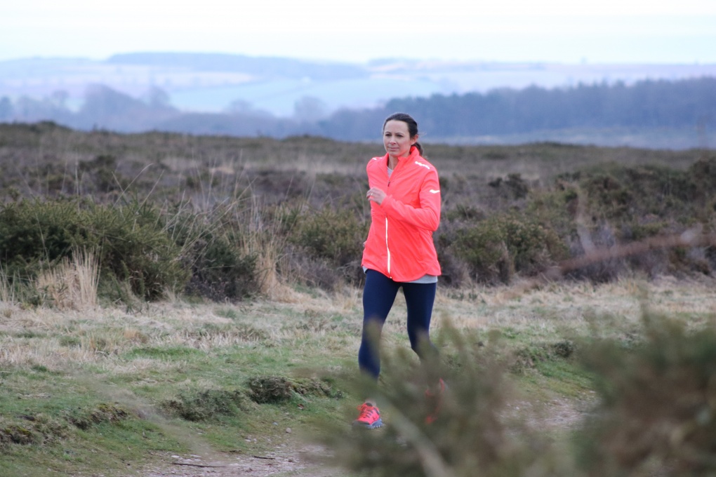 Athlete Jo Pavey running along a trail